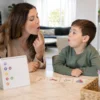 How long does articulation therapy take shown by parent and child practicing mouth placement with flashcards at Let's Talk Speech and Language Therapy Mission Viejo CA