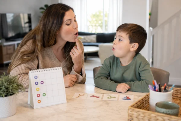 How long does articulation therapy take shown by parent and child practicing mouth placement with flashcards at Let's Talk Speech and Language Therapy Mission Viejo CA